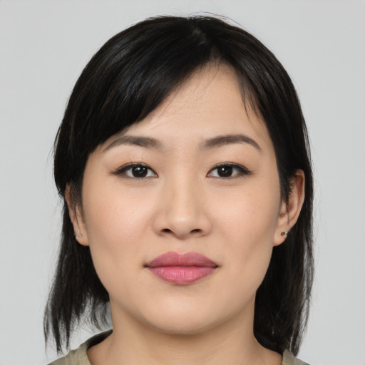 Joyful asian young-adult female with medium  black hair and brown eyes