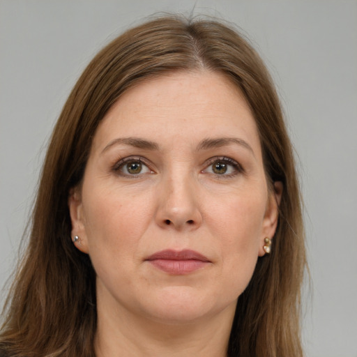 Joyful white adult female with long  brown hair and brown eyes