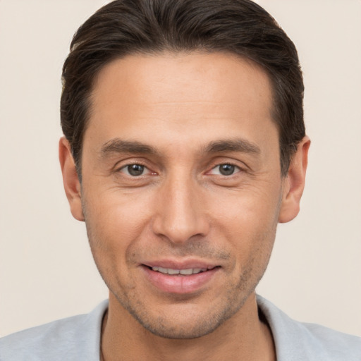 Joyful white adult male with short  brown hair and brown eyes