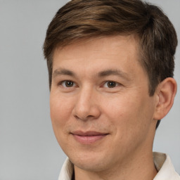 Joyful white adult male with short  brown hair and brown eyes