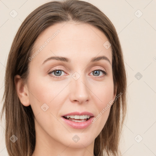 Joyful white young-adult female with long  brown hair and blue eyes