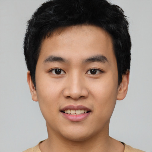 Joyful asian young-adult male with short  black hair and brown eyes