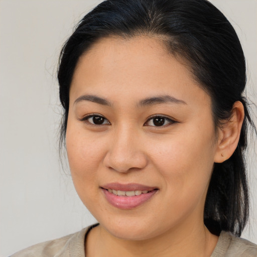 Joyful latino young-adult female with medium  brown hair and brown eyes