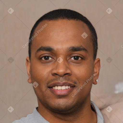 Joyful black young-adult male with short  black hair and brown eyes