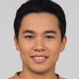 Joyful asian young-adult male with short  brown hair and brown eyes