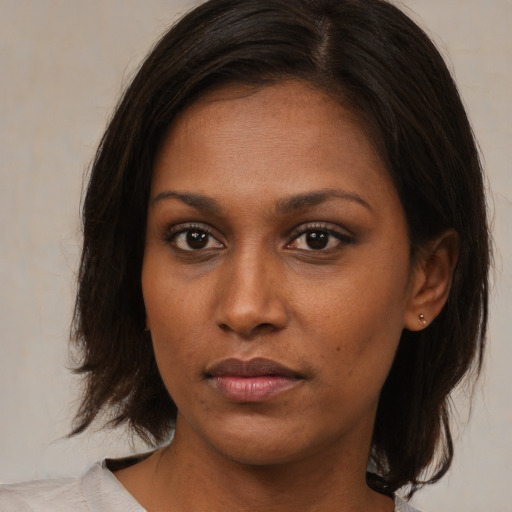 Neutral black young-adult female with medium  brown hair and brown eyes