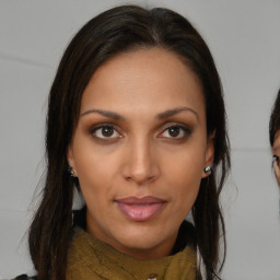 Joyful black young-adult female with medium  brown hair and brown eyes