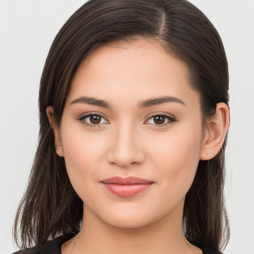 Joyful white young-adult female with long  brown hair and brown eyes