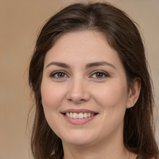 Joyful white young-adult female with long  brown hair and brown eyes