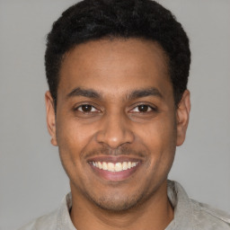 Joyful latino young-adult male with short  brown hair and brown eyes