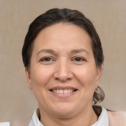 Joyful white adult female with short  brown hair and brown eyes