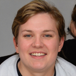 Joyful white young-adult female with medium  brown hair and blue eyes