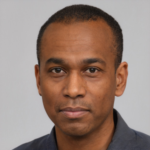Neutral black adult male with short  black hair and brown eyes
