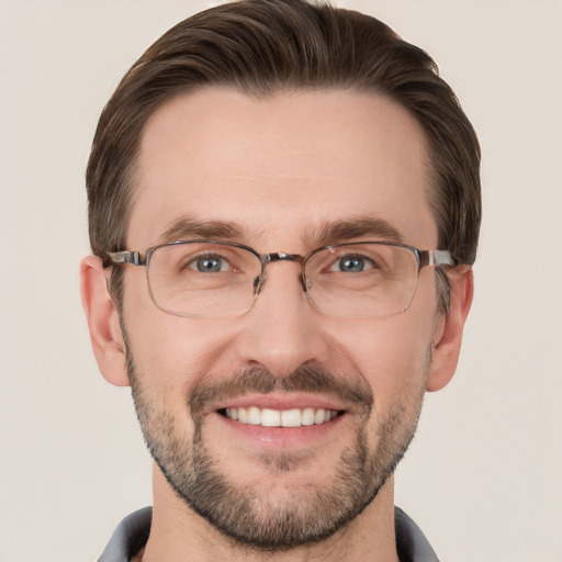 Joyful white adult male with short  brown hair and grey eyes