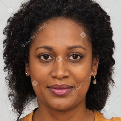 Joyful black young-adult female with long  brown hair and brown eyes