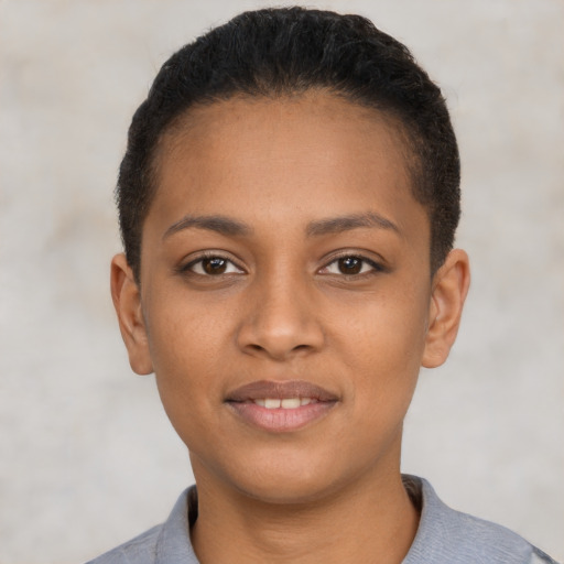 Joyful latino young-adult female with short  black hair and brown eyes