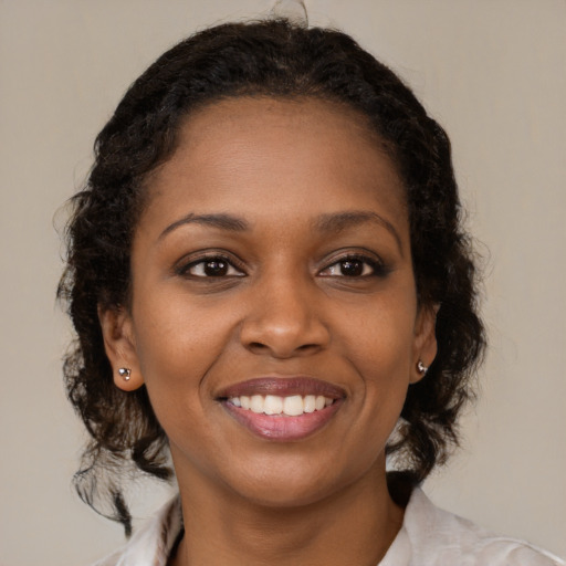 Joyful black young-adult female with medium  brown hair and brown eyes