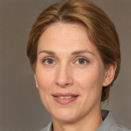 Joyful white adult female with medium  brown hair and grey eyes