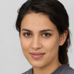 Joyful latino young-adult female with medium  brown hair and brown eyes