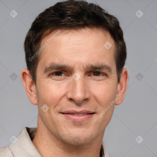 Joyful white adult male with short  brown hair and brown eyes