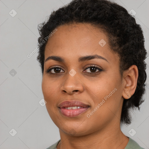 Joyful black young-adult female with short  black hair and brown eyes