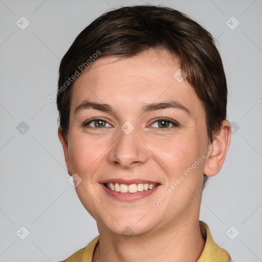 Joyful white young-adult female with short  brown hair and grey eyes