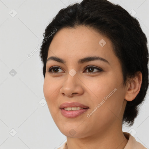 Joyful latino young-adult female with short  black hair and brown eyes