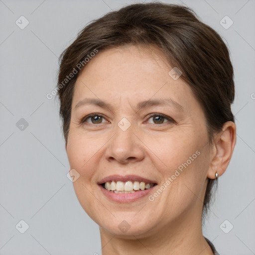 Joyful white adult female with short  brown hair and brown eyes