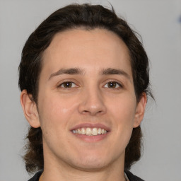 Joyful white young-adult male with medium  brown hair and brown eyes