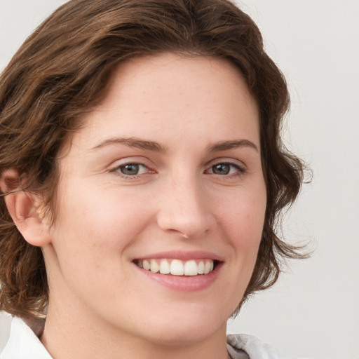 Joyful white young-adult female with medium  brown hair and green eyes