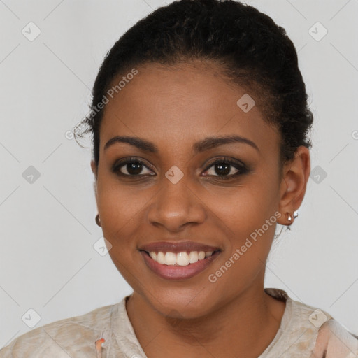 Joyful black young-adult female with short  brown hair and brown eyes