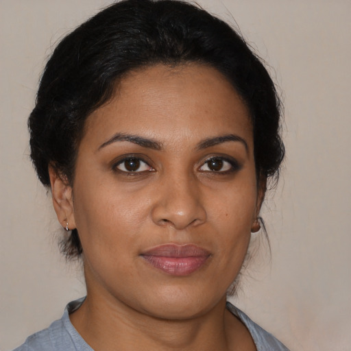 Joyful black young-adult female with medium  brown hair and brown eyes