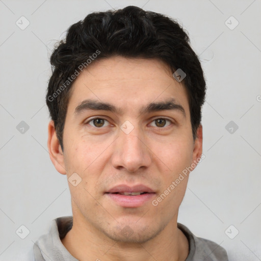 Joyful white young-adult male with short  black hair and brown eyes