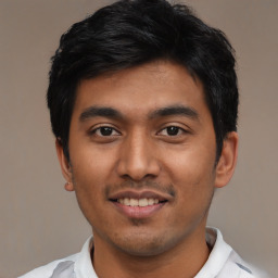 Joyful latino young-adult male with short  black hair and brown eyes