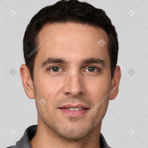 Joyful white young-adult male with short  brown hair and grey eyes