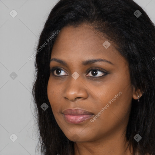 Joyful black young-adult female with long  brown hair and brown eyes