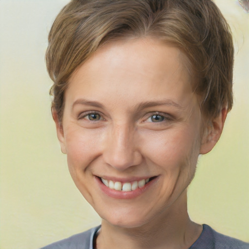 Joyful white adult female with short  brown hair and grey eyes