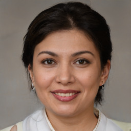 Joyful white adult female with medium  brown hair and brown eyes