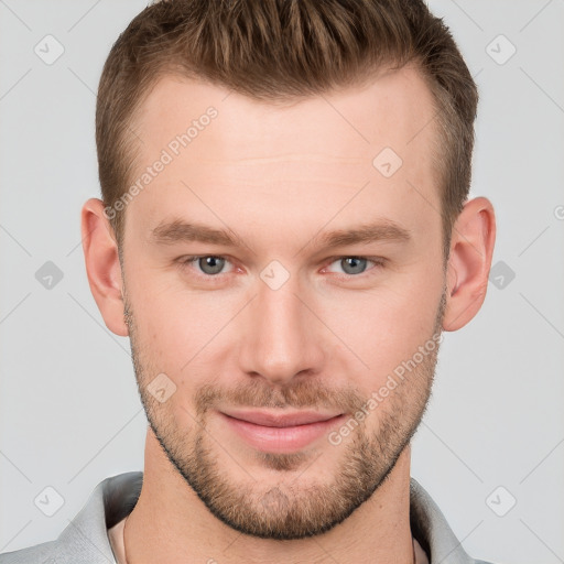 Joyful white young-adult male with short  brown hair and grey eyes