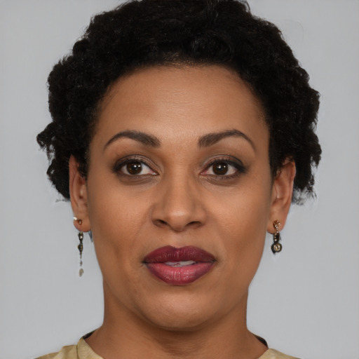 Joyful black adult female with short  brown hair and brown eyes
