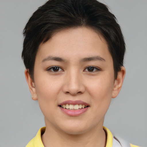 Joyful asian young-adult female with short  brown hair and brown eyes