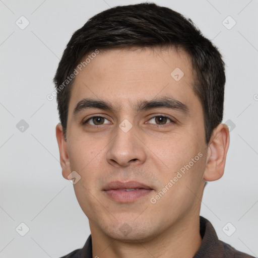 Joyful white young-adult male with short  black hair and brown eyes