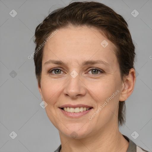 Joyful white adult female with short  brown hair and brown eyes