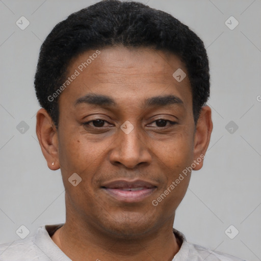 Joyful black adult male with short  black hair and brown eyes