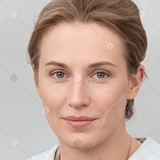 Joyful white young-adult female with medium  brown hair and blue eyes