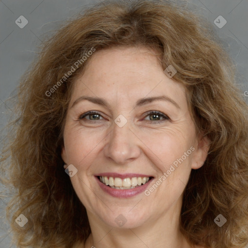 Joyful white adult female with long  brown hair and brown eyes