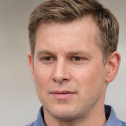 Joyful white adult male with short  brown hair and grey eyes