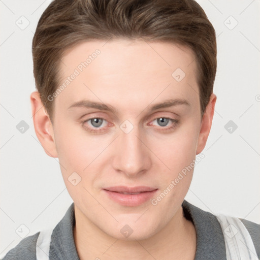 Joyful white young-adult male with short  brown hair and grey eyes