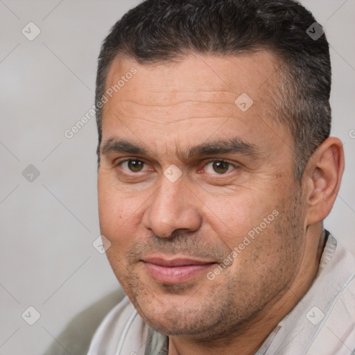 Joyful white adult male with short  brown hair and brown eyes