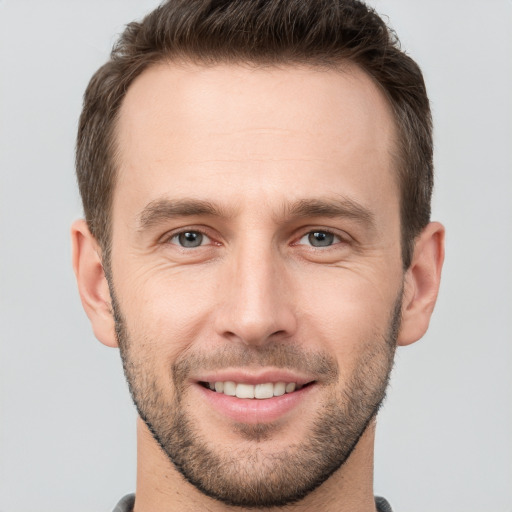 Joyful white young-adult male with short  brown hair and brown eyes